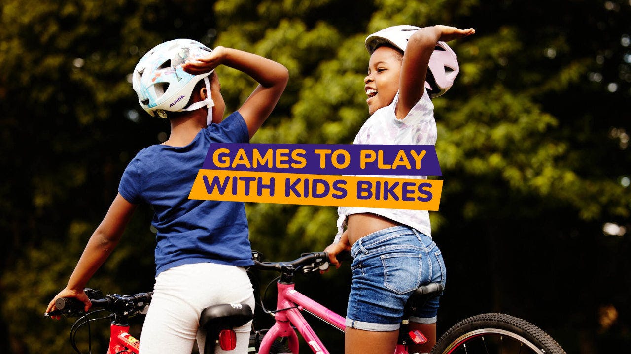 two kids high fiving on bikes - bike club