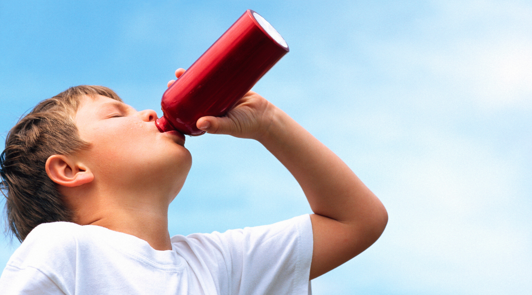 child drinking from reusable water bottle