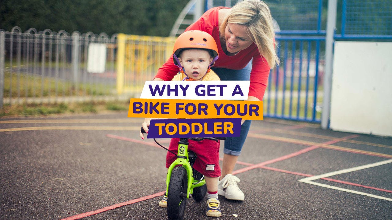 toddler and parent with balance bike