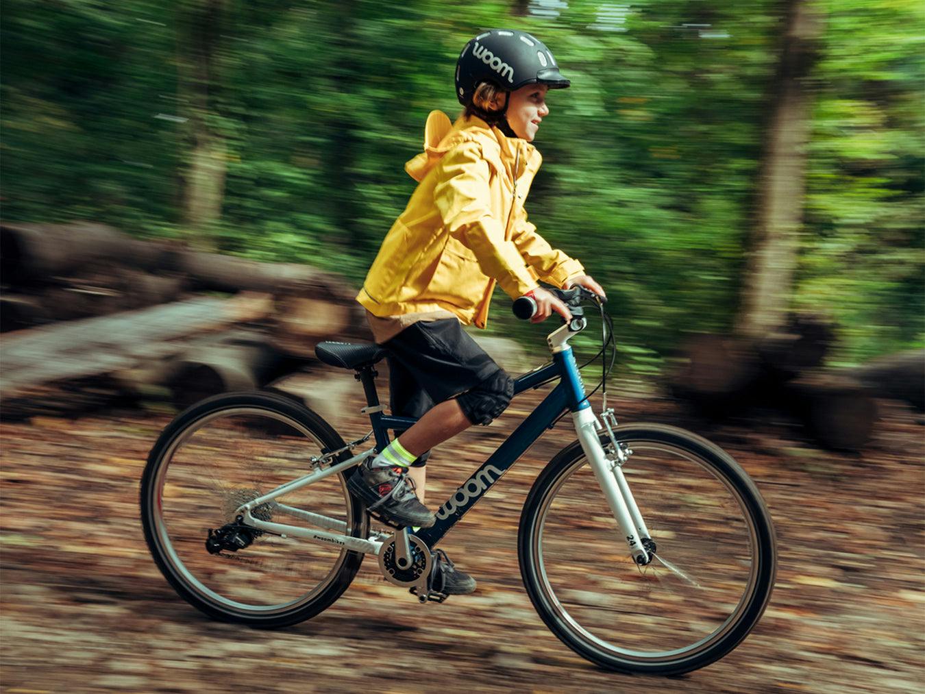 child riding a Woom 5 - bike club