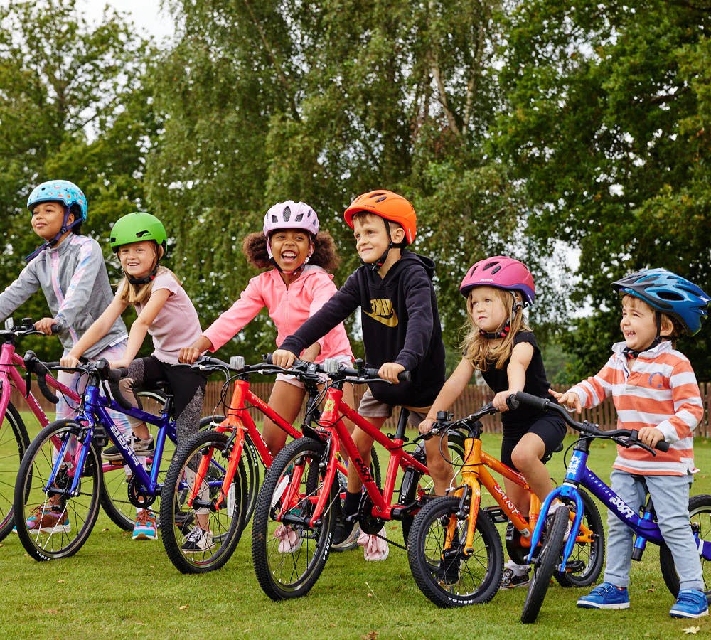 Kids of all ages enjoying a range of different sized bikes from Bike Club