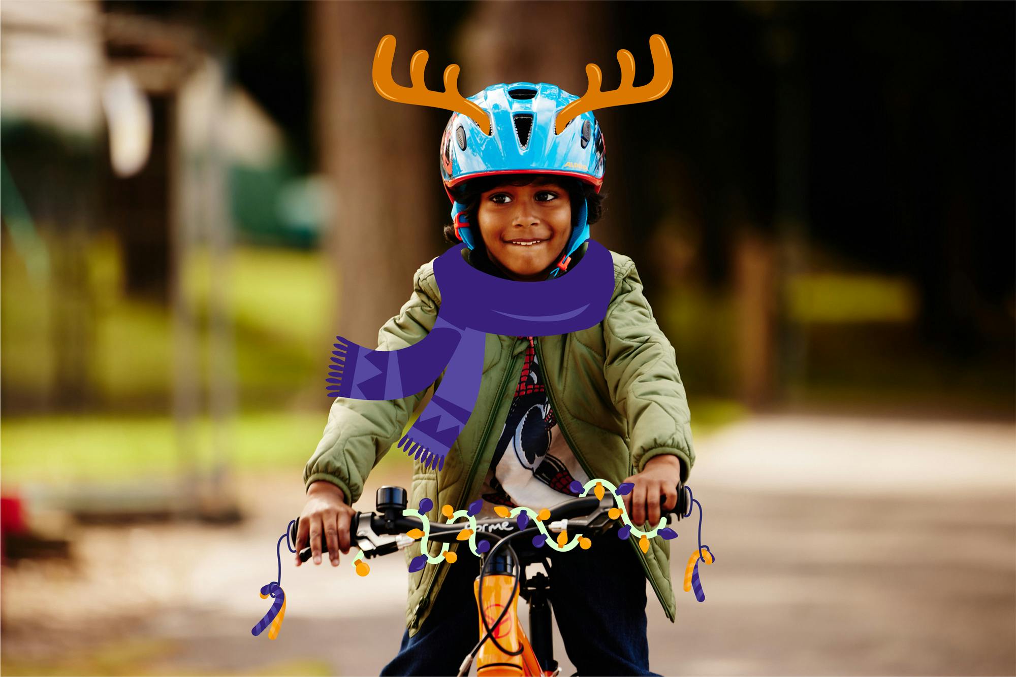A child with a Christmas helmet on a bike